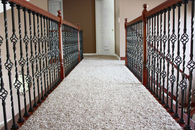 Inspiration for a small carpeted hallway remodel in Toronto with brown walls