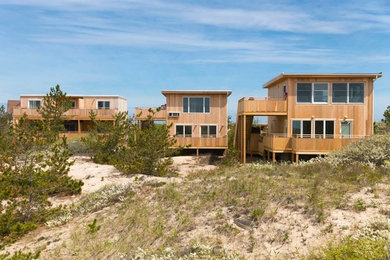 Inspiration for a large beach style two-storey brown exterior in New York with wood siding.