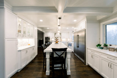 Design ideas for a large traditional kitchen in Cincinnati with white cabinets, engineered stone countertops, beige splashback, marble splashback, vinyl flooring, an island, brown floors, white worktops and a coffered ceiling.