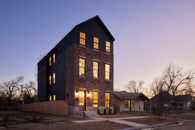 Inspiration for a mid-sized contemporary red three-story brick exterior home remodel in Oklahoma City with a metal roof and a gray roof