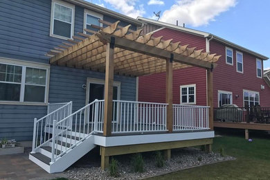 Inspiration for a large contemporary backyard deck remodel in Minneapolis with a pergola