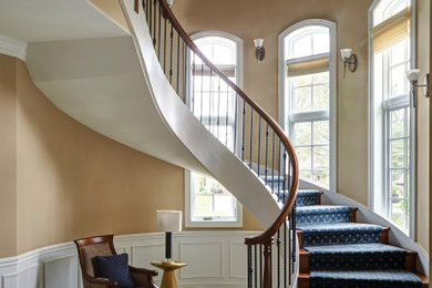 Inspiration for a large timeless wooden curved wood railing staircase remodel in Chicago with wooden risers