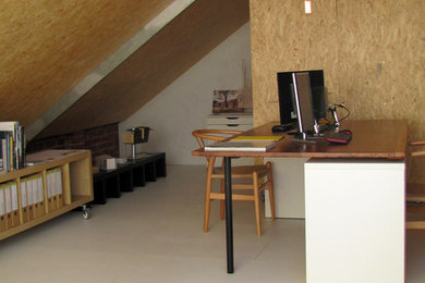 Mid-sized home studio in Geelong with painted wood floors and a freestanding desk.