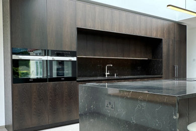 Inspiration for a large contemporary l-shaped open plan kitchen in Sussex with an island.