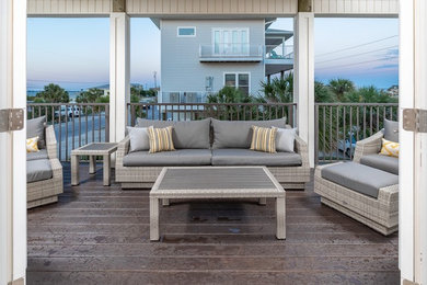 Large beach style metal railing balcony container garden photo in Other with a roof extension