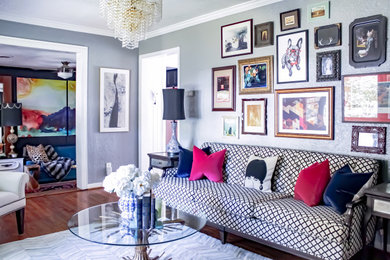 Example of a mid-sized eclectic enclosed and formal medium tone wood floor living room design with no fireplace and gray walls