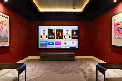 Medium sized contemporary enclosed home cinema in London with red walls, carpet, a projector screen and beige floors.