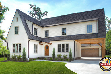 Large transitional white two-story stucco house exterior idea in Cleveland with a clipped gable roof and a shingle roof