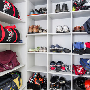 Inspiration for an expansive contemporary u-shaped utility room in Kent with a single-bowl sink, shaker cabinets, grey cabinets, laminate countertops, grey walls, ceramic flooring, a side by side washer and dryer, yellow floors and grey worktops.