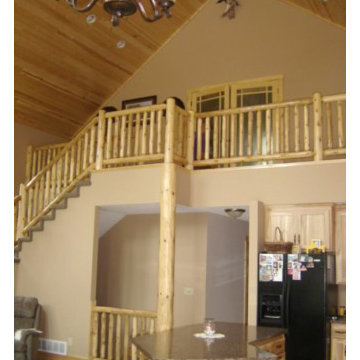 Loft with custom log railing and log accents