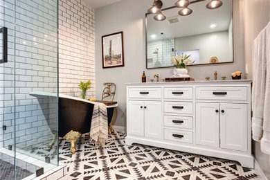 Example of a mid-sized transitional master white tile and ceramic tile cement tile floor and black floor bathroom design in Los Angeles with shaker cabinets, white cabinets, a two-piece toilet, gray walls, an undermount sink, marble countertops, a hinged shower door and gray countertops