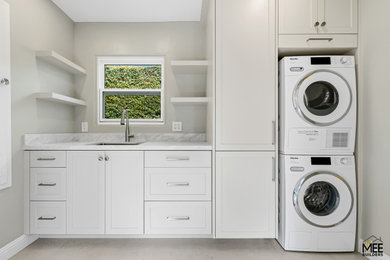 Minimalist laundry room photo in San Diego with marble countertops