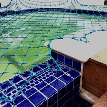 Culver backyard with child safety net over now usable spa.
