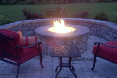 Design ideas for a small traditional backyard patio in Boston with a fire feature, natural stone pavers and no cover.