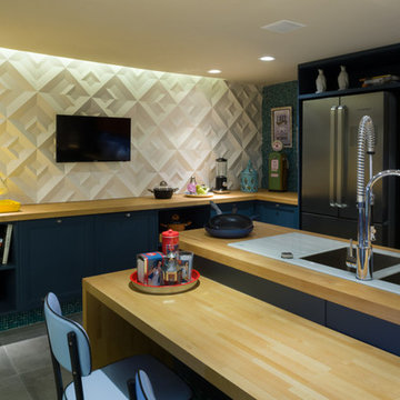 Modern blue kitchen with cement wall