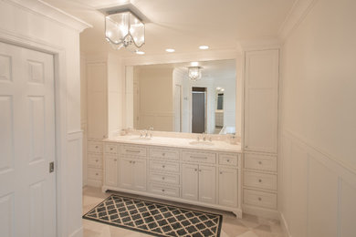 Mid-sized elegant master beige tile and stone tile marble floor bathroom photo in Minneapolis with an undermount sink, beaded inset cabinets, white cabinets, marble countertops, a two-piece toilet and white walls