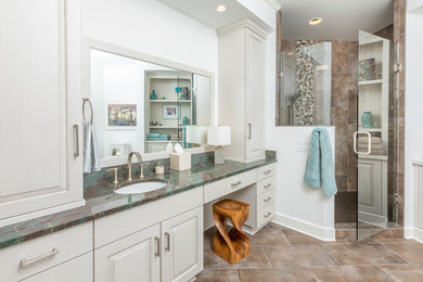 Example of a large transitional master brown tile brown floor and ceramic tile wet room design in Other with raised-panel cabinets, white cabinets, white walls, an undermount sink, a hinged shower door and quartzite countertops