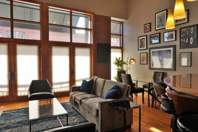 Living room - small 1950s loft-style and formal medium tone wood floor and yellow floor living room idea in Denver with gray walls and no tv
