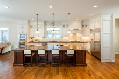 Eat-in kitchen - mid-sized transitional l-shaped eat-in kitchen idea in Phoenix with an undermount sink, white cabinets, granite countertops, multicolored backsplash, stainless steel appliances and an island