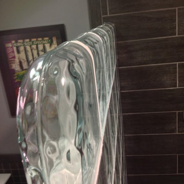Thinner series glass block walk in shower in a rustic contemporary basement bath