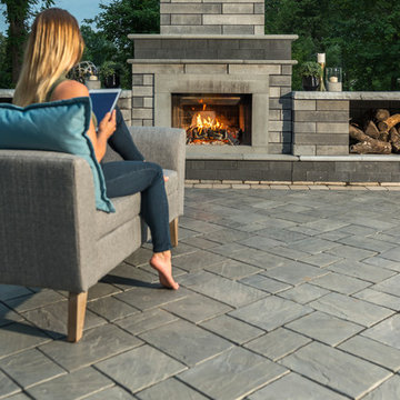 Reading a tablet and enjoying a Richcliff patio and Moda fireplace