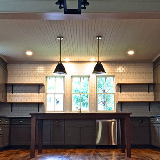Mid-sized craftsman kitchen pantry photos - Inspiration for a mid-sized craftsman u-shaped light wood floor kitchen pantry remodel in Nashville with an undermount sink, shaker cabinets, gray cabinets, granite countertops, white backsplash, subway tile backsplash, stainless steel appliances and an island