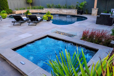 Example of a small transitional backyard stone and kidney-shaped hot tub design in Toronto