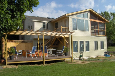 Inspiration for a large craftsman backyard patio remodel in Minneapolis with a pergola