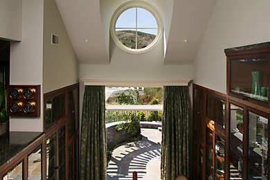 Entryway - mid-sized traditional medium tone wood floor and brown floor entryway idea in San Francisco with white walls and a brown front door