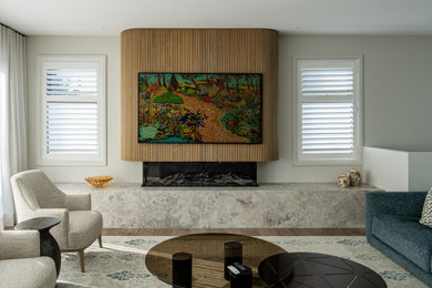 This is an example of a large contemporary living room in Melbourne with a stone fireplace surround and a wall-mounted tv.