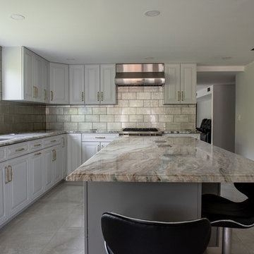 Transitional Kitchen Done in a 2 Tone Color With Integrated Dining Table