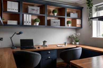 Photo of a medium sized classic study in West Midlands with grey walls, medium hardwood flooring, a built-in desk and brown floors.