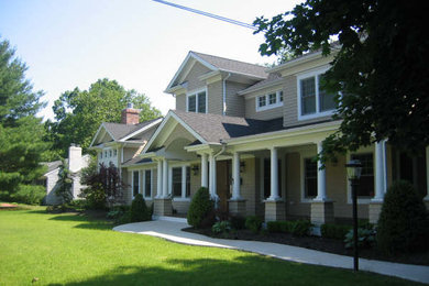 This is an example of a mid-sized country front yard verandah in New York.
