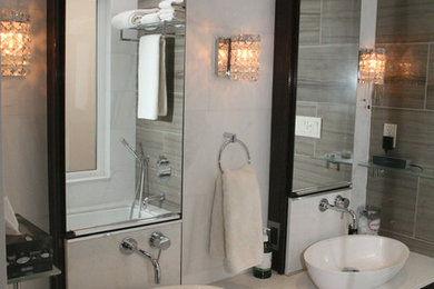 Bathroom - mid-sized transitional master beige tile mosaic tile floor and beige floor bathroom idea in Toronto with flat-panel cabinets, black cabinets, white walls, a vessel sink, quartz countertops and a hinged shower door