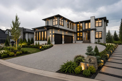 Large trendy gray two-story stucco exterior home photo in Calgary with a shingle roof and a black roof