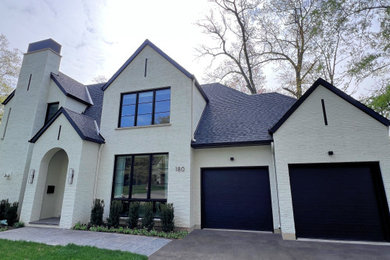 Large transitional white two-story brick exterior home photo in Toronto with a shingle roof and a black roof