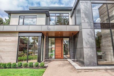 Example of a trendy gray two-story metal exterior home design in Toronto with a metal roof