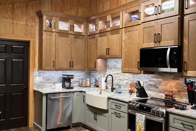 Mountain style kitchen photo in Atlanta with a farmhouse sink, shaker cabinets, granite countertops and stone tile backsplash