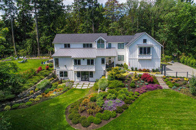 Inspiration for a large farmhouse full sun hillside stone landscaping in Seattle.