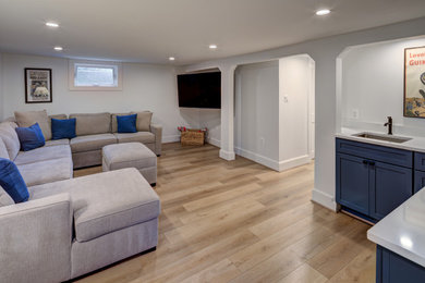 Inspiration for a huge transitional look-out light wood floor and beige floor basement remodel in DC Metro with a home theater and gray walls