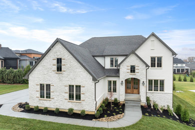 Example of a large transitional two-story brick and clapboard house exterior design in Cincinnati