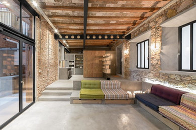 Living room - large industrial formal and open concept concrete floor living room idea in Barcelona with no tv