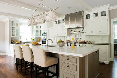 Example of a trendy l-shaped dark wood floor eat-in kitchen design in Other with a drop-in sink, raised-panel cabinets, white cabinets, granite countertops, white backsplash and an island