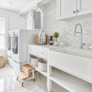 Traditional separated utility room in Detroit with an utility sink, recessed-panel cabinets, white cabinets, white walls, a side by side washer and dryer, white floors and white worktops.
