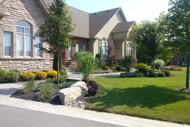 Photo of a mid-sized transitional full sun front yard garden path in Toronto.
