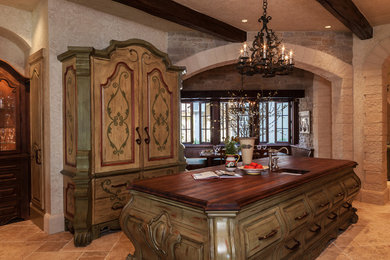 Photo of a large traditional eat-in kitchen in Salt Lake City with raised-panel cabinets, distressed cabinets, wood benchtops, travertine floors, a single-bowl sink and with island.
