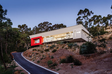 Mid-sized contemporary two-storey white house exterior in Perth with mixed siding, a flat roof and a metal roof.