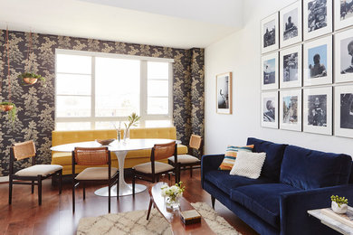 Living room - mid-sized eclectic loft-style medium tone wood floor living room idea in Los Angeles with white walls and no fireplace