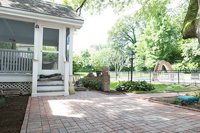 Large traditional backyard patio in St Louis with concrete pavers.