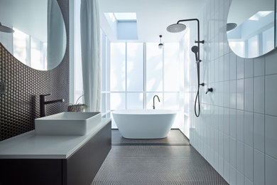 This is an example of a mid-sized contemporary bathroom in Other with a freestanding tub, an open shower, white tile, a vessel sink, engineered quartz benchtops, an open shower, white benchtops, a single vanity and a freestanding vanity.